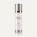 A tall cylindrical bottle of Eleven Eleven Skincare Barrier Repair Hand Cream, featuring a metallic silver cap and base with a white body, set against a light beige background with a soft reflection.